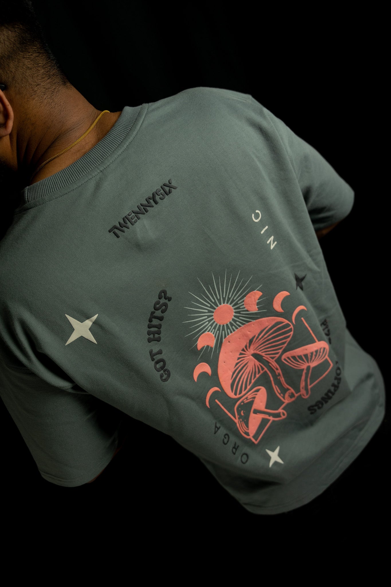 Model showcasing the back side of the Twennysix Shroom Dreams T-shirt.