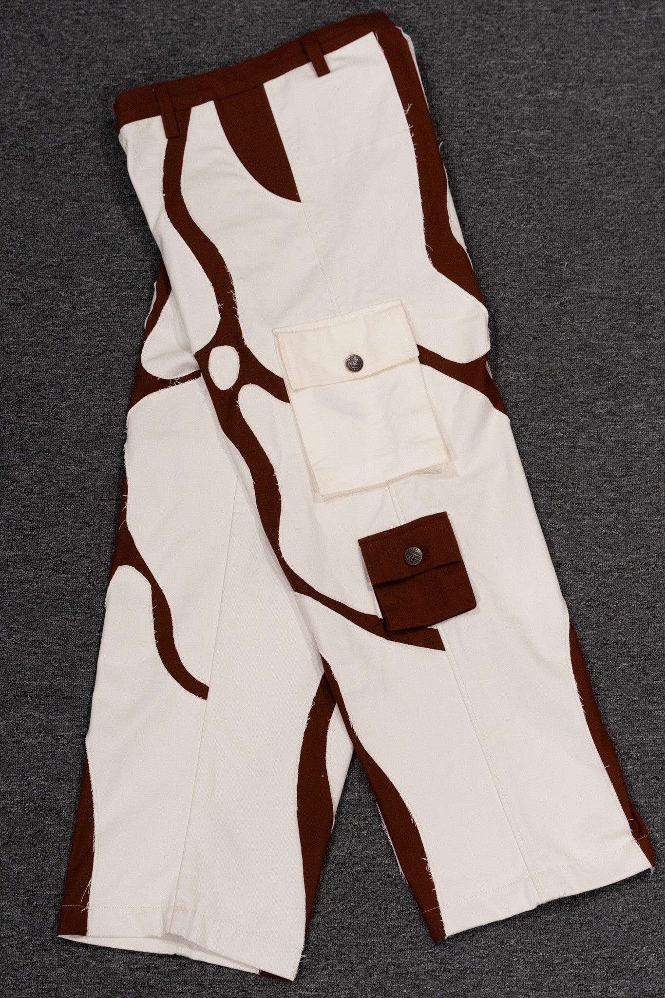 Half front and half back view of MochaBlend Cargo Pant, displaying its unique fusion of brown and white cotton fabric.