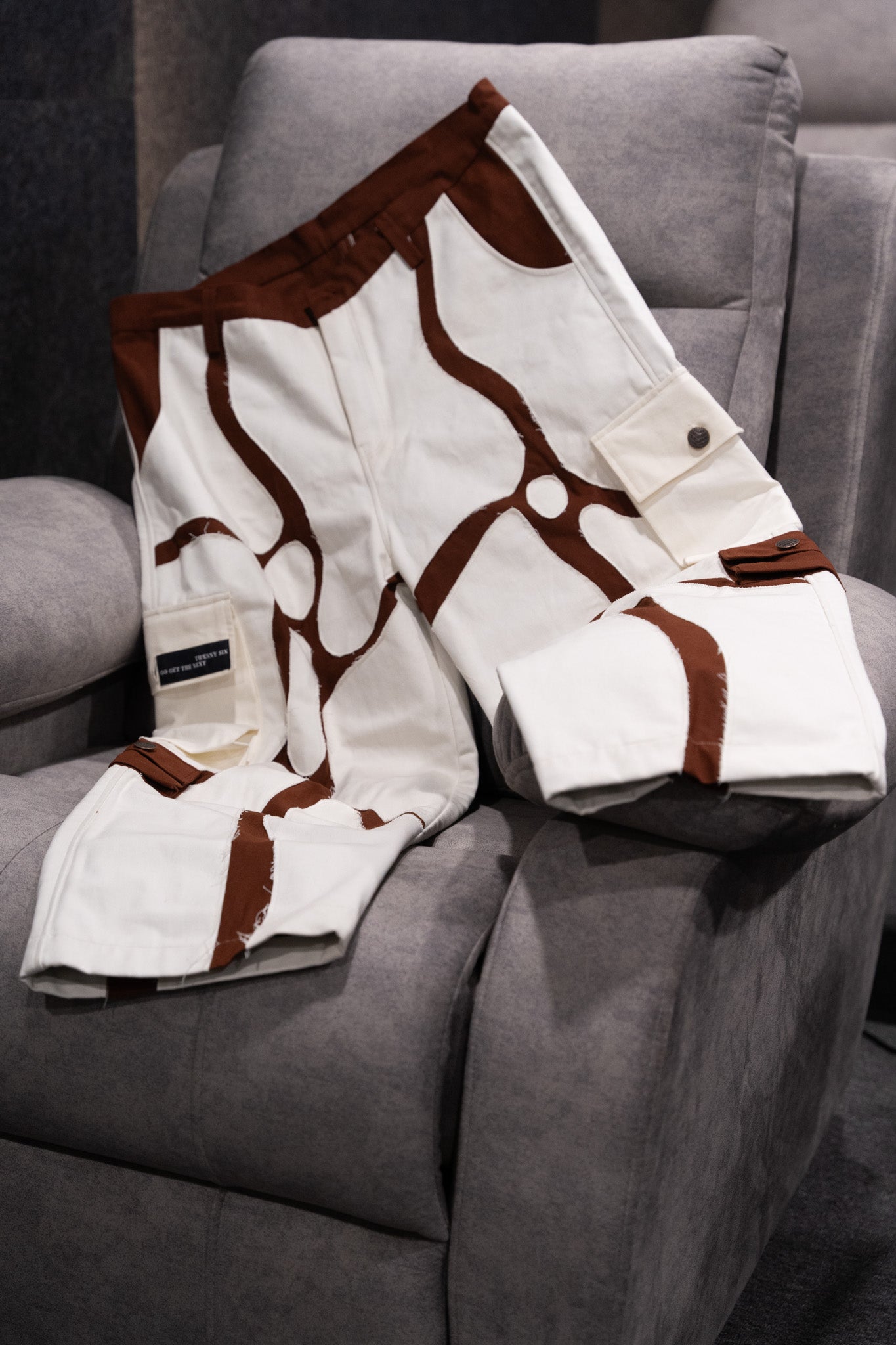 Cargo pant displayed on a sofa, showcasing its versatile design and rugged authenticity.