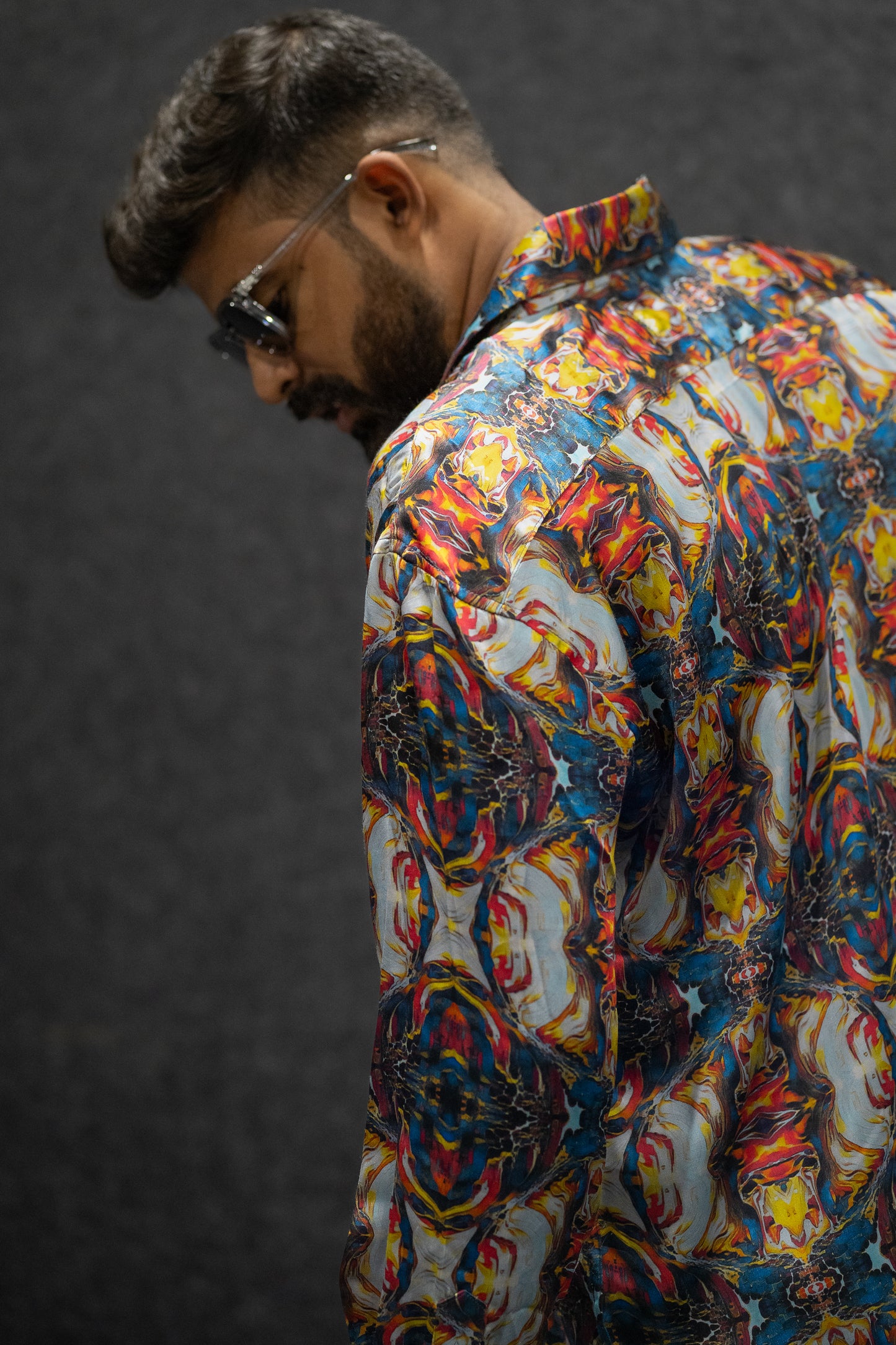 Side view of a model wearing the Lunar Mirage shirt, showcasing its unique lunar-inspired pattern and stylish design.