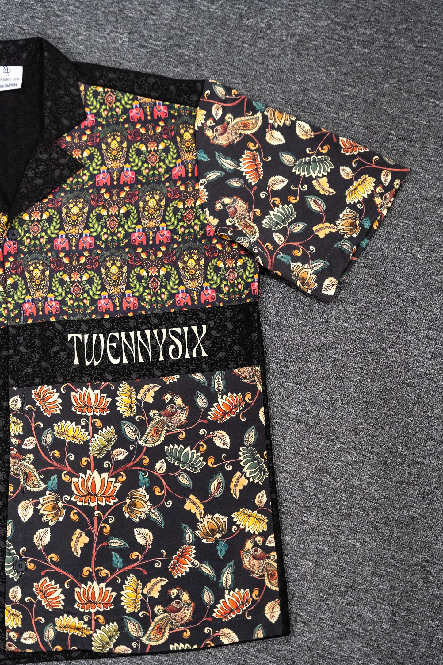 Flat lay of Twennysix Kalamkari Fusion Shirt, focusing on one side to highlight the intricate Kalamkari prints and unique design features for a fashionable statement piece.