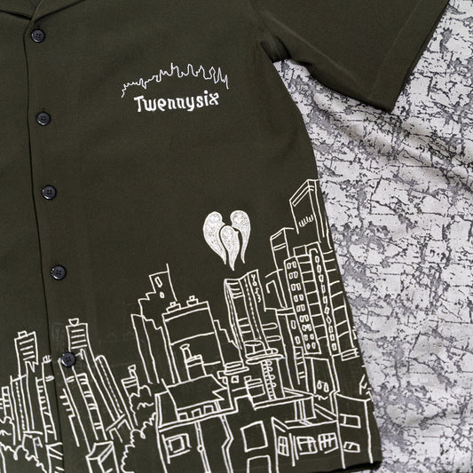 Flat lay close-up of Skyscraper Shirt with intricate building embroidery and three ghost motifs