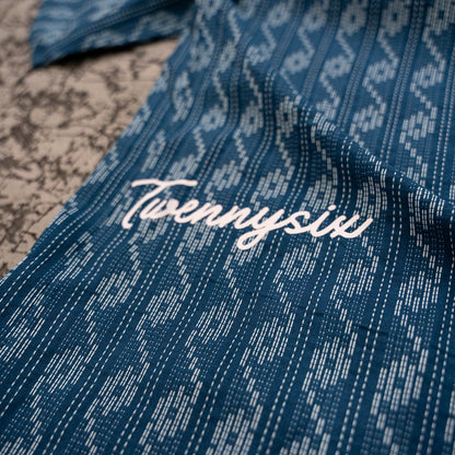 Close-up image showcasing the screen print branding on the blue wave Kantha shirt, featuring the Twennysix logo.