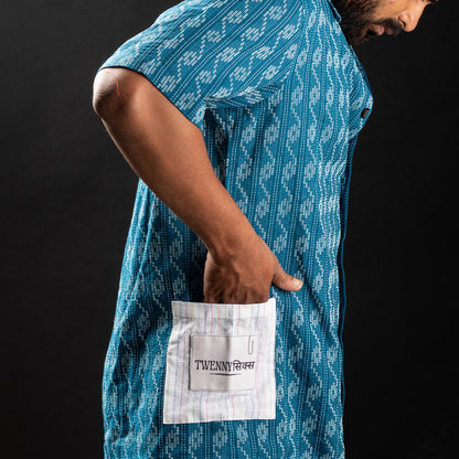 Detailed view of the white Kantha pockets with Twennysix branding patch on the side of the blue wave Kantha shirt.