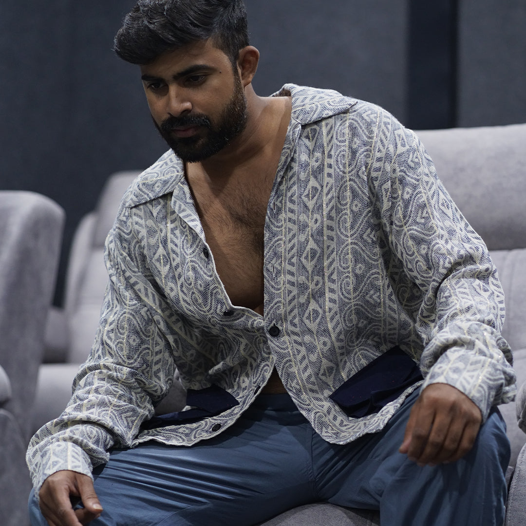 Male model showcases Lurex Slate Shirt sitting, highlighting fit and style.